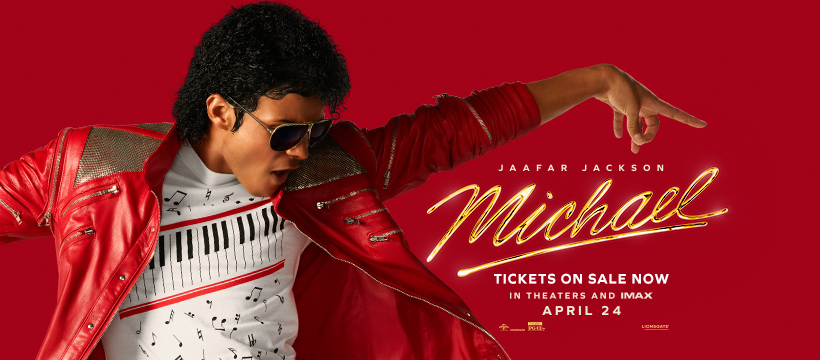 A promotional image featuring a young man dressed in a red jacket and a white shirt with a piano keyboard design, striking a dynamic pose against a red background. The text on the image announces a movie titled 'Michael,' with details about ticket sales for theaters and IMAX.